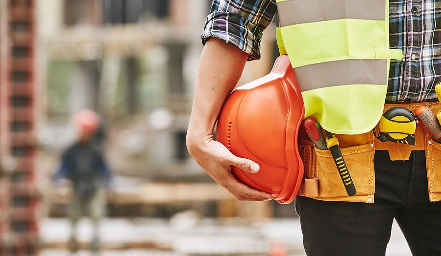 Construction worker holding helmet